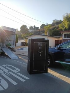 A heavy safe being moved from a residence onto a truck by Rough Çutt Movers in San Diego, CA