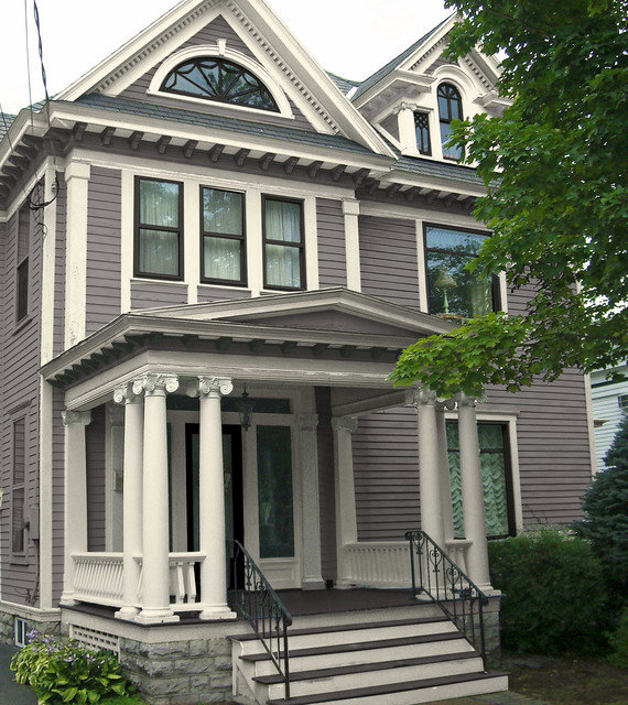 A historic home showcasing gray horizontal siding and intricate white trim, a project by Bushco Contracting LLC in Fresno, CA.