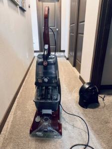 A Hoover Power Scrub carpet cleaner machine ready for use by Dust Detail Cleaning Services in Post Falls, ID.