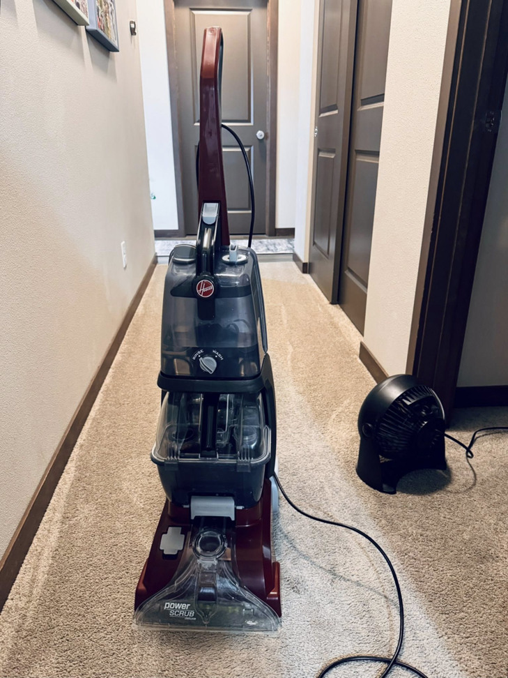 A Hoover Power Scrub carpet cleaner machine ready for use by Dust Detail Cleaning Services in Post Falls, ID.
