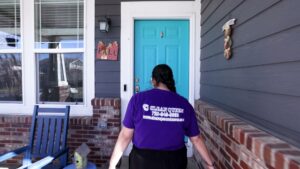 A house cleaner from Clean Queen House Cleaning arriving at a client's home in Arvada, CO, ready to start a job.