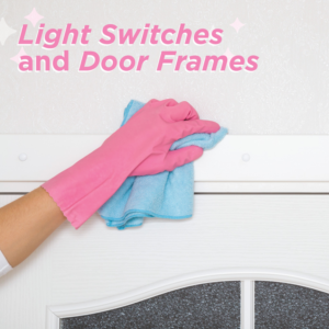 A Molly Maid house cleaner wiping a light switch and door frame in a home in Albuquerque, NM.