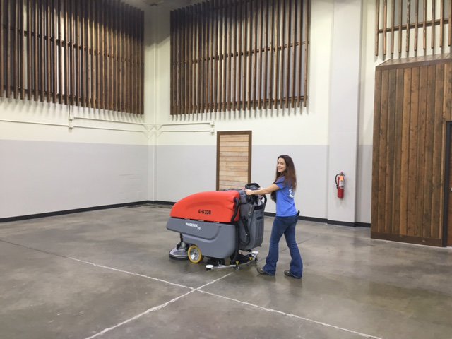 Two house cleaners from ADW Cleaning LLC vacuuming and dusting a home in Springfield, OR.