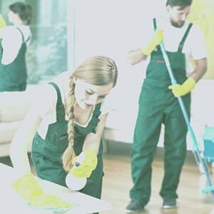 Two house cleaners from Eco Safe Clean wiping a surface and mopping a floor in Miami Beach, FL