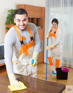 Professional house cleaners wiping a table and mopping a floor for All Advanced Tactical Klean LLC in Columbus, OH.