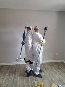 Professional house cleaners in protective gear holding mops and brooms, ready for a deep clean by Just Like Magic in Marina Del Rey, CA.