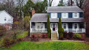 A beautiful home with newly installed dark blue siding and white trim by My Guys Remodeling Experts in Bethel Park, PA.