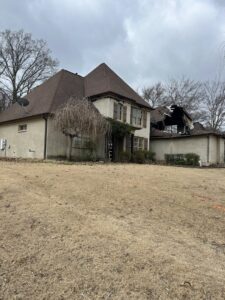 A house undergoing demolition with significant roof damage, handled by East Shelby Demolition & Pool Removal in Olive Branch, MS.
