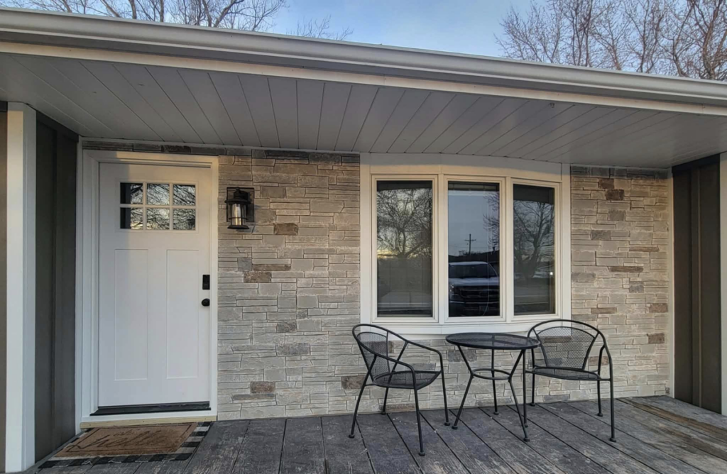 Front of a house showcasing stone veneer and vertical siding installed by D.A. Siding & Windows in Grand Island, NE.
