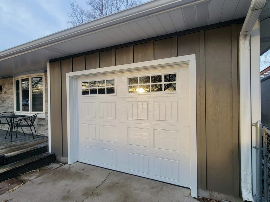 Front of a house featuring new vertical siding and a white garage door by D.A. Siding & Windows in Grand Island, NE.
