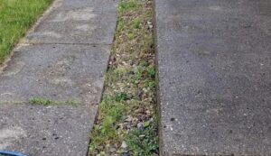 Before and after comparison of house siding cleaned by Satisfaction Cleaning in Athens, AL, showing significant improvement.