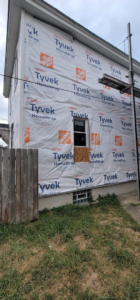 Another view of a house wrapped in Tyvek HomeWrap, indicating siding preparation by Lap Vinyl Siding Repair Columbus OH.