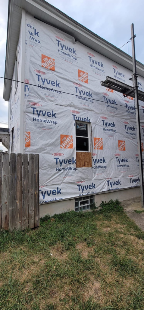 Another view of a house wrapped in Tyvek HomeWrap, indicating siding preparation by Lap Vinyl Siding Repair Columbus OH.