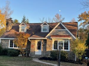 Charming house with stone facade and new gray siding installed by High Quality Exteriors in Rockville, MD.