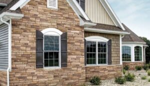 A house featuring a combination of stone and horizontal siding installed by Storm Group Roofing in Brooklyn Park, MN.