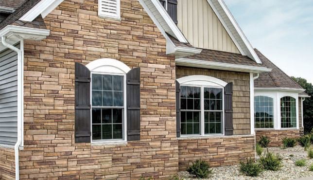A house featuring a combination of stone and horizontal siding installed by Storm Group Roofing in Brooklyn Park, MN.