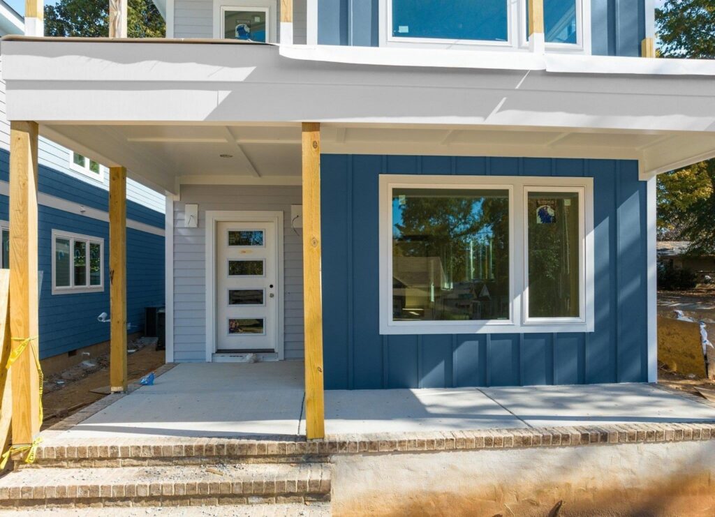 A house under construction with new blue vertical and horizontal siding installed by Ideal Siding Winston-Salem, NC.