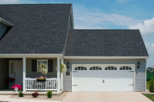 A house with a classic white garage door featuring windows and hardware by Jim Dyer Overhead Door in Carson City, NV