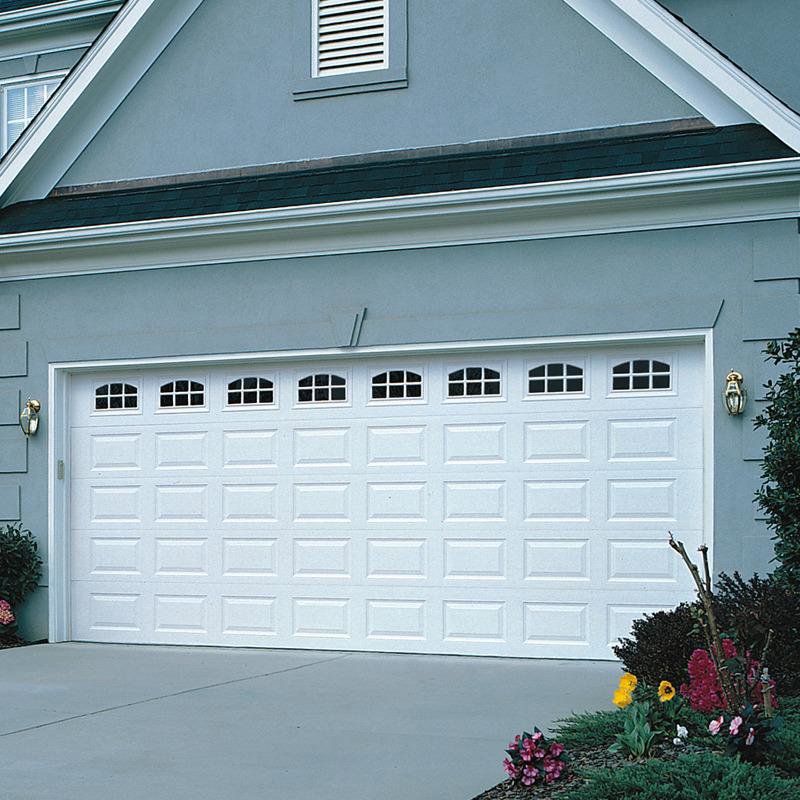 A home featuring a wide white garage door with a row of windows along the top, a service provided by Overhead Door Company of Salt Lake in Sandy, UT.