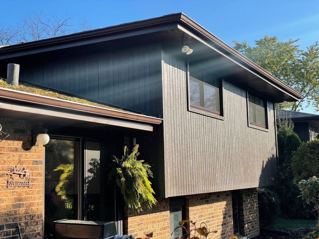 A residential home featuring new dark brown vertical siding installed by A&D Exteriors in Naperville, IL.