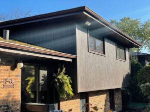 A residential home featuring new dark brown vertical siding installed by A&D Exteriors in Naperville, IL.