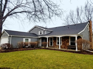A beautiful home featuring new gray horizontal siding and stone accents by A&D Exteriors in Naperville, IL.