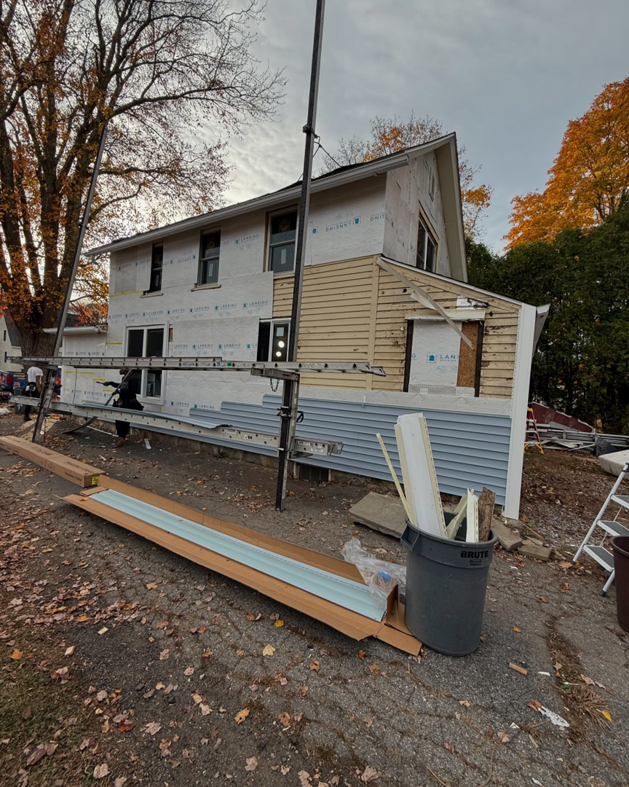 A house undergoing new siding installation by J&J Rivera Roofing and Supply Co in Old Saybrook, CT