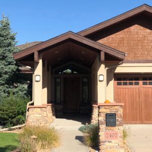 A beautiful house featuring wood shake siding and stucco, completed by Urban Exteriors LLC in Lakewood, CO.