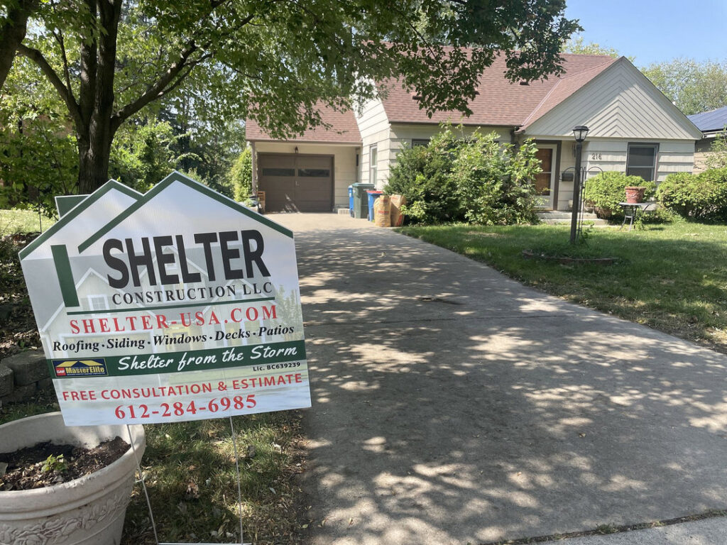 A house wrapped in house wrap with scaffolding, ready for siding installation by Shelter Construction LLC in Brooklyn Park, MN.