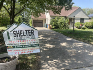 A house wrapped in house wrap with scaffolding, ready for siding installation by Shelter Construction LLC in Brooklyn Park, MN.