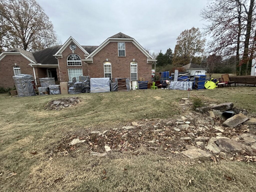 Household items and furniture, wrapped and ready for moving outside a home by Gifted Hands Moving & Storage in Collierville, TN.