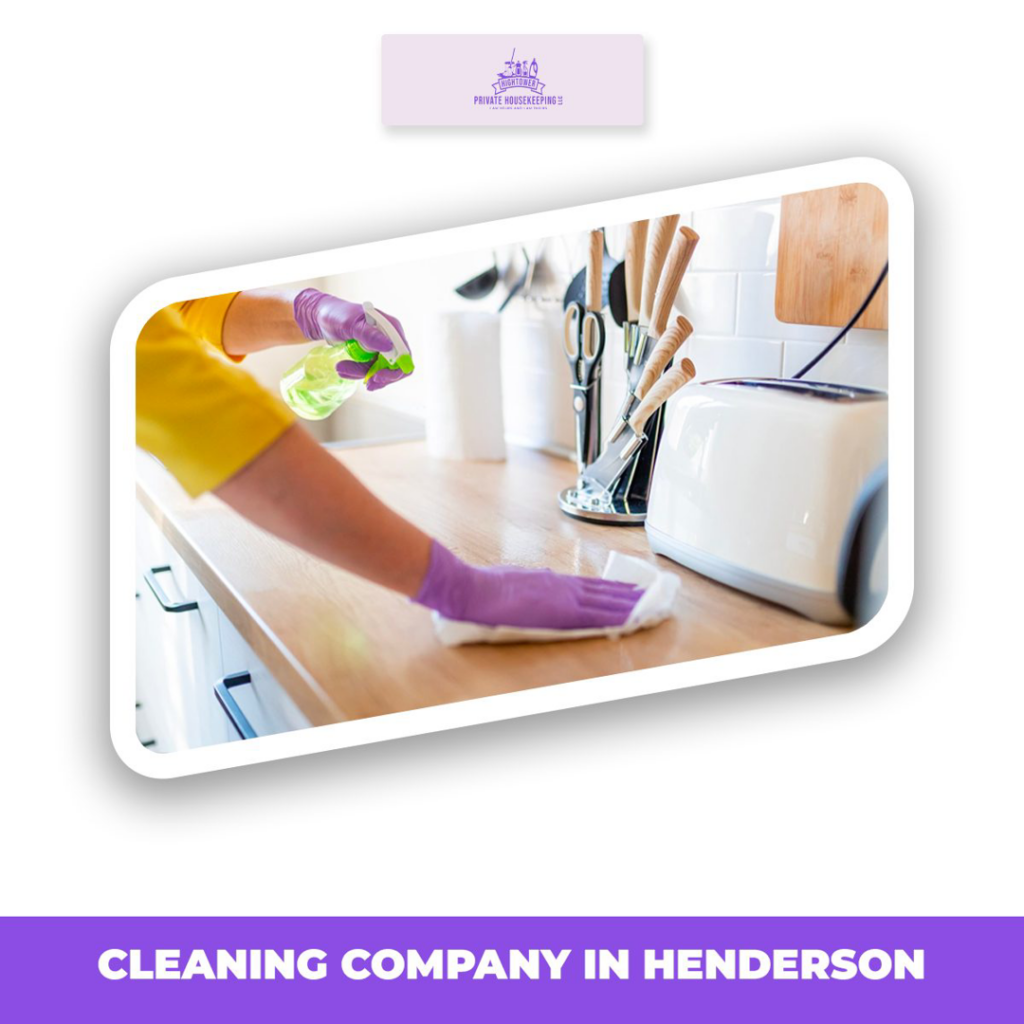A housekeeper wearing purple gloves cleaning a kitchen countertop for Hightower Private Housekeeping in Henderson, NV.