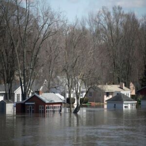 Houses partially submerged in extensive floodwaters, showing severe water damage in O Fallon, MO.
