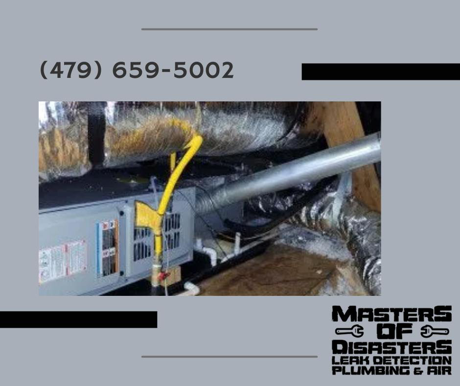 An HVAC unit in an attic showing signs of water damage and a leak, handled by Masters of Disasters in Springdale, AR