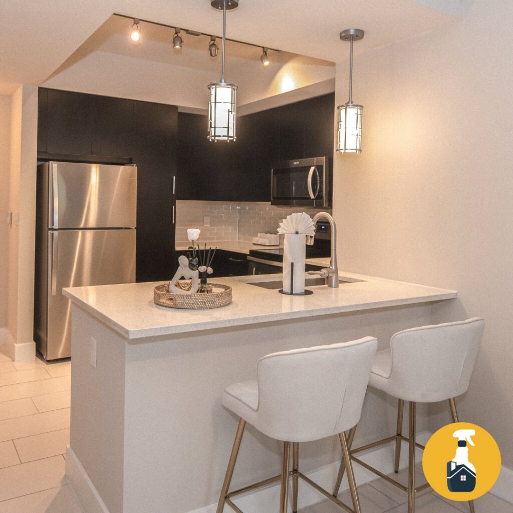 An immaculate kitchen with a breakfast bar and stainless steel appliances, cleaned by The Prime Cleaner in Miami, FL.