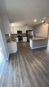 An immaculate, open-concept kitchen with clean counters and appliances, showcasing cleaning by Jr services in Virginia Beach, VA.