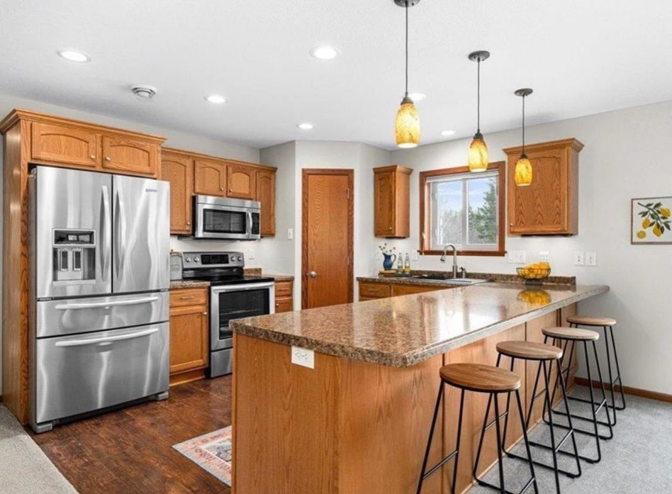 An immaculate kitchen with stainless steel appliances and granite countertops, professionally cleaned by Tidy Details in Duluth, MN.