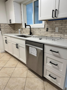 An immaculate kitchen featuring white cabinets and clean countertops, cleaned by Dust Detail Cleaning Services in Post Falls, ID.
