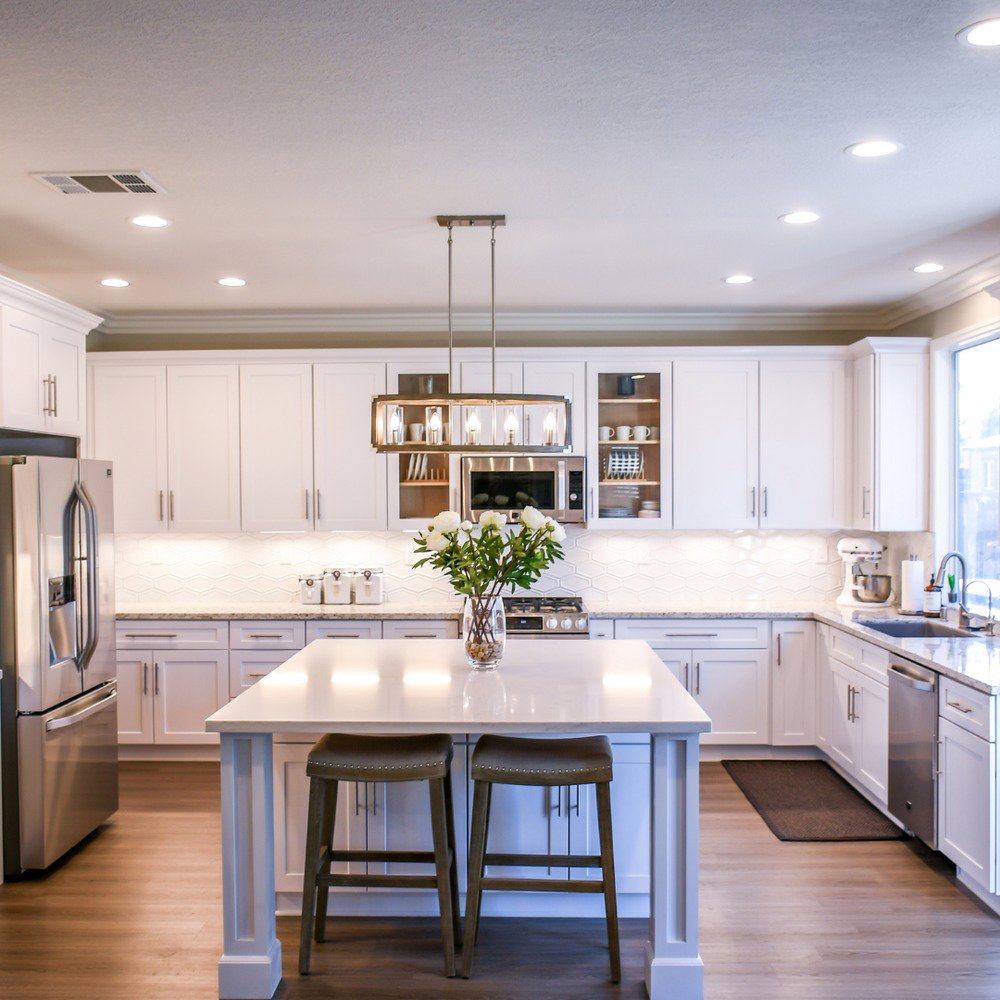 An immaculate modern kitchen with white cabinets, showcasing the results of house cleaning by Time To Shine Cleaning Services in Round Rock, TX.