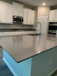 An immaculate modern kitchen with a large island and gleaming appliances, cleaned to perfection by Simply Clean Jax in Jacksonville, FL.