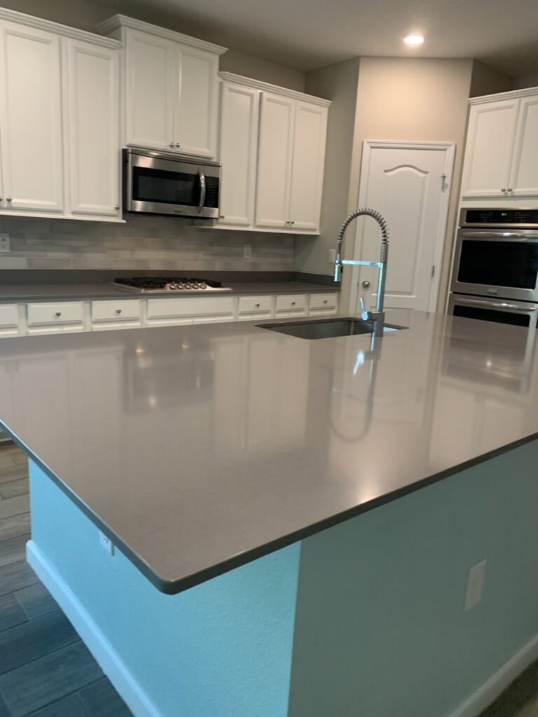 An immaculate modern kitchen with a large island and gleaming appliances, cleaned to perfection by Simply Clean Jax in Jacksonville, FL.