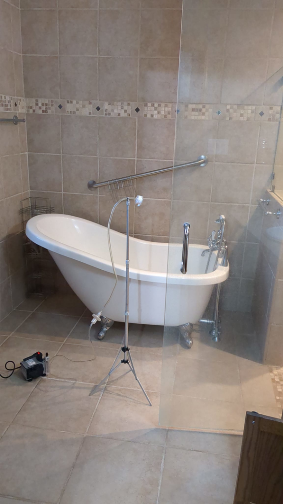 Indoor air sampling equipment set up in a bathroom for mold testing by Peak Home Pro Restoration in Clovis, NM.