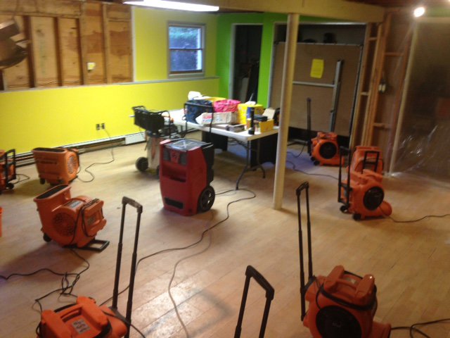 Industrial air movers and dehumidifiers set up for water damage drying by CleanBright Surface Restoration in Latham, NY.