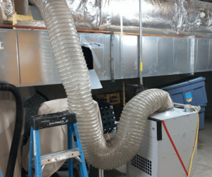 Industrial drying equipment with large hoses used for water damage restoration by COIT Cleaning and Restoration in Indianapolis, IN.