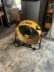 A large industrial fan used for drying a wet area after water damage at a Highland Restoration job in Hampton, VA