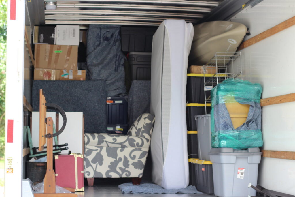 The inside of a moving truck efficiently packed with various furniture and household items by PittMovers in McKees Rocks, PA