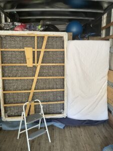 Inside a Next Step Moving truck, showing a mattress and box spring packed for transport in Eau Claire, WI.