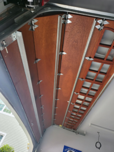 An inside view of garage door panels and hinges, showcasing components serviced by DNA Garage Door Repair in New Haven, CT