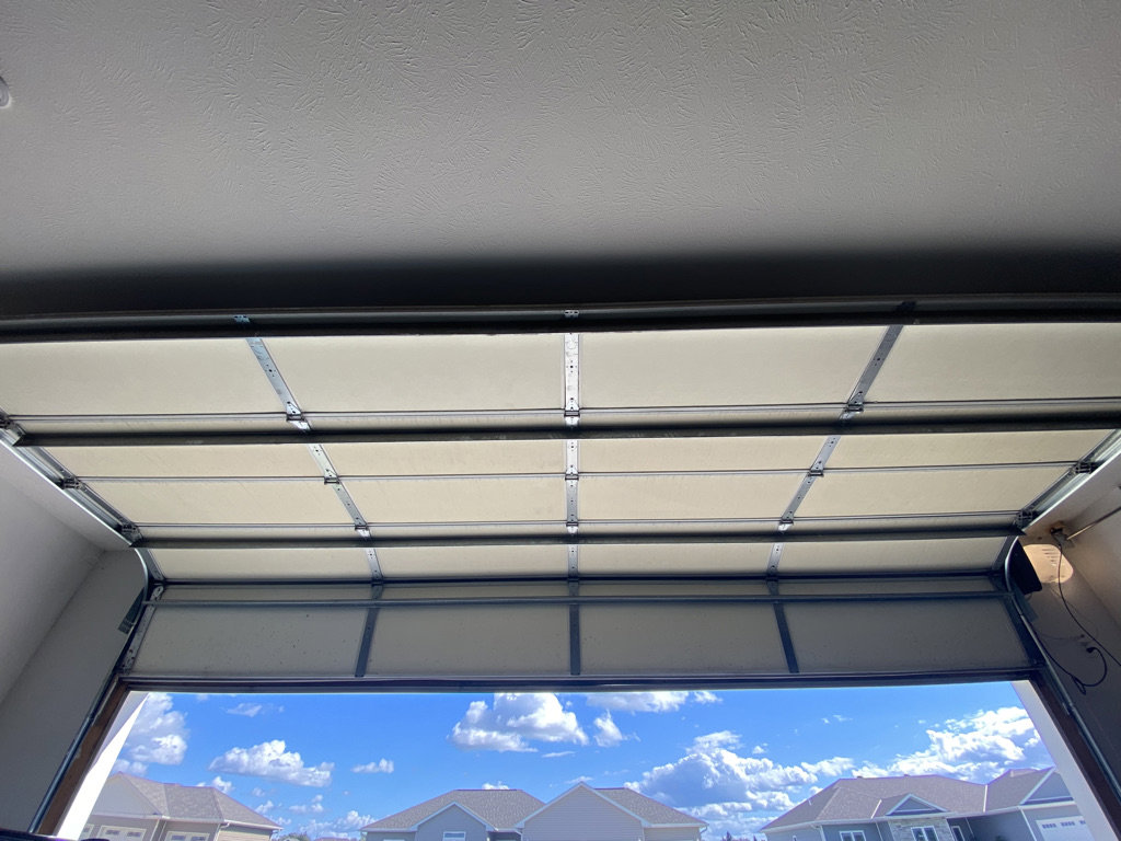An inside view of an open garage door, showcasing the installation and structure by Bob McDonald Garage Door LLC in Columbus, NE.