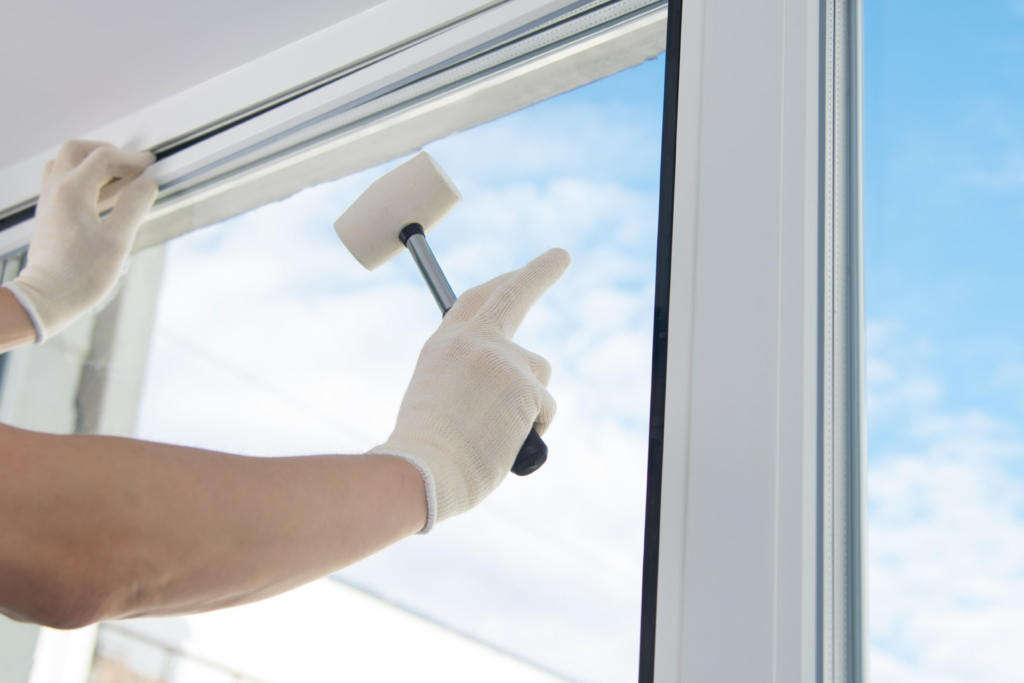 Hands in gloves installing a window seal to ensure watertight integrity by Papillion Windows & Siding - NE in Papillion, NE.